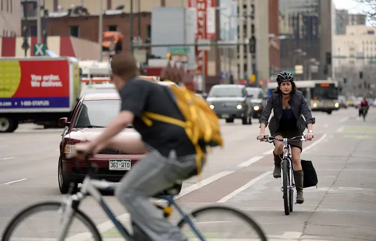 Woman on Bike in Traffic